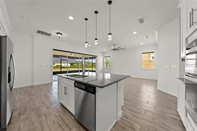 an aerial view of residential houses with outdoor space and ocean view