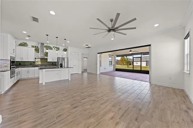 an aerial view of residential houses with outdoor space and ocean view