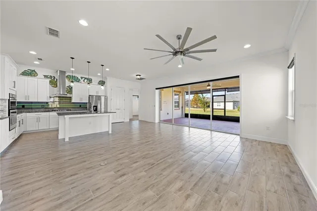 a kitchen with stainless steel appliances granite countertop a refrigerator a sink and a stove