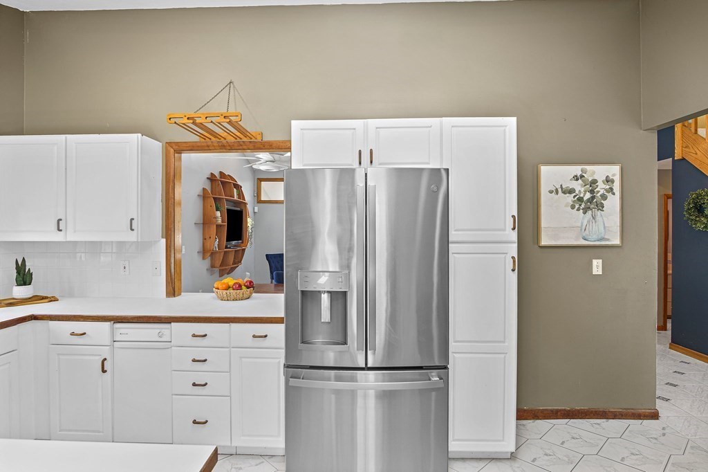 118 Beach Road Salisbury, MA 01952 - Photo 12 of 29 a kitchen with stainless steel appliances a refrigerator and cabinets