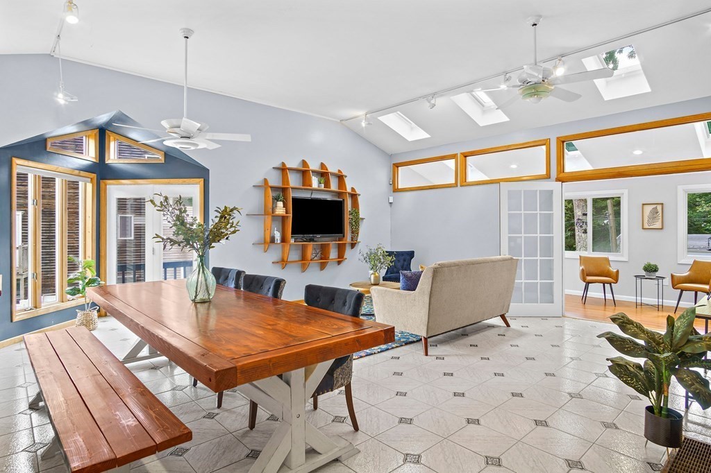 118 Beach Road Salisbury, MA 01952 - Photo 7 of 29 a dining room with furniture a chandelier and wooden floor