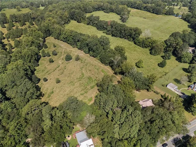 an aerial view of a houses with a yard