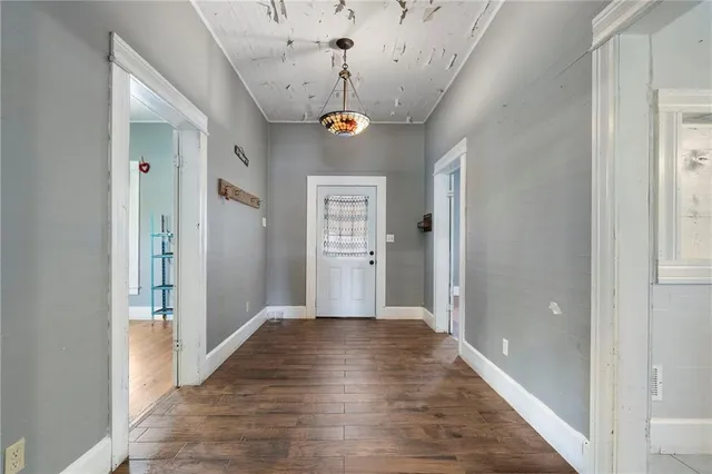a view of a hallway with wooden floor