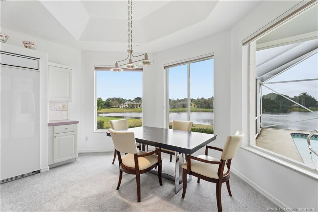 800 Southeast Waterside Way Stuart, FL 34997 - Photo 17 of 27 a dining room with furniture a chandelier and wooden floor