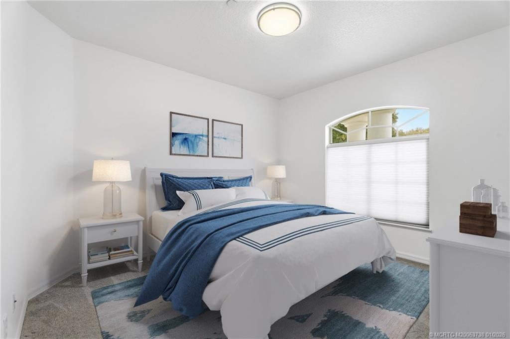 800 Southeast Waterside Way Stuart, FL 34997 - Photo 18 of 27 a bedroom with a bed and a window
