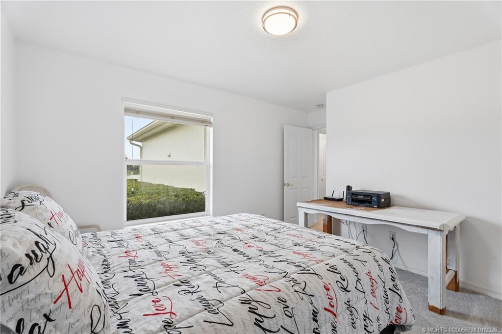800 Southeast Waterside Way Stuart, FL 34997 - Photo 22 of 27 a bedroom with a bed and a dresser
