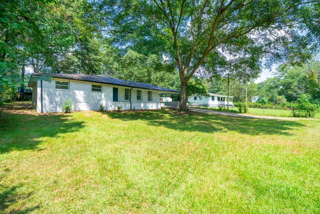 419 Westside School Road Newnan, GA 30263 - Photo 1 of 1 a view of a house with a big yard and large trees