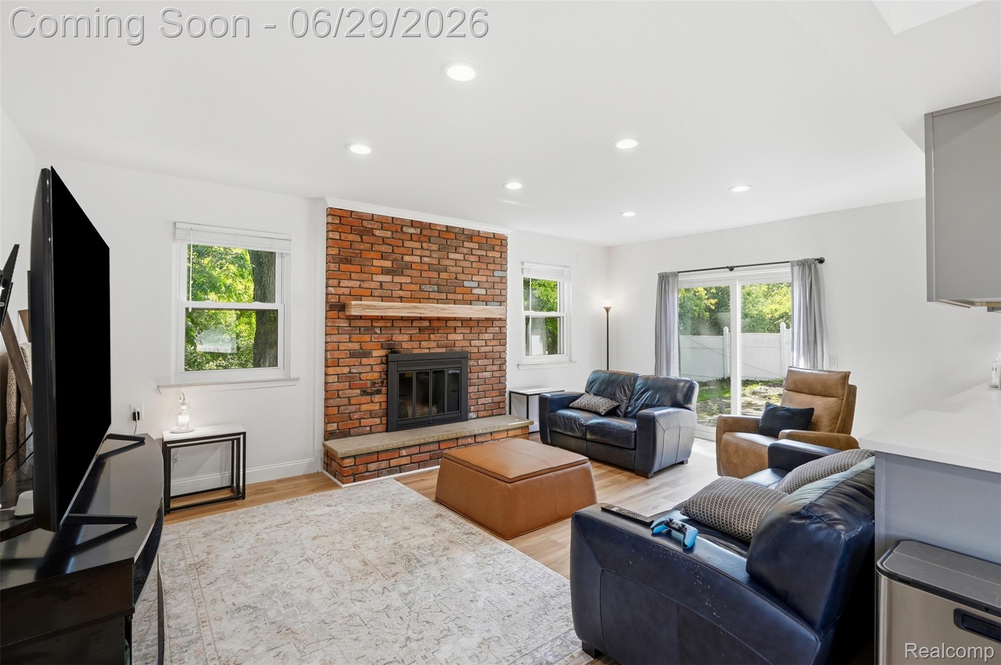 45179 Rudgate Road Canton, MI 48188 - Photo 8 of 48 Living area featuring a brick fireplace with a stone hearth and wood mantel