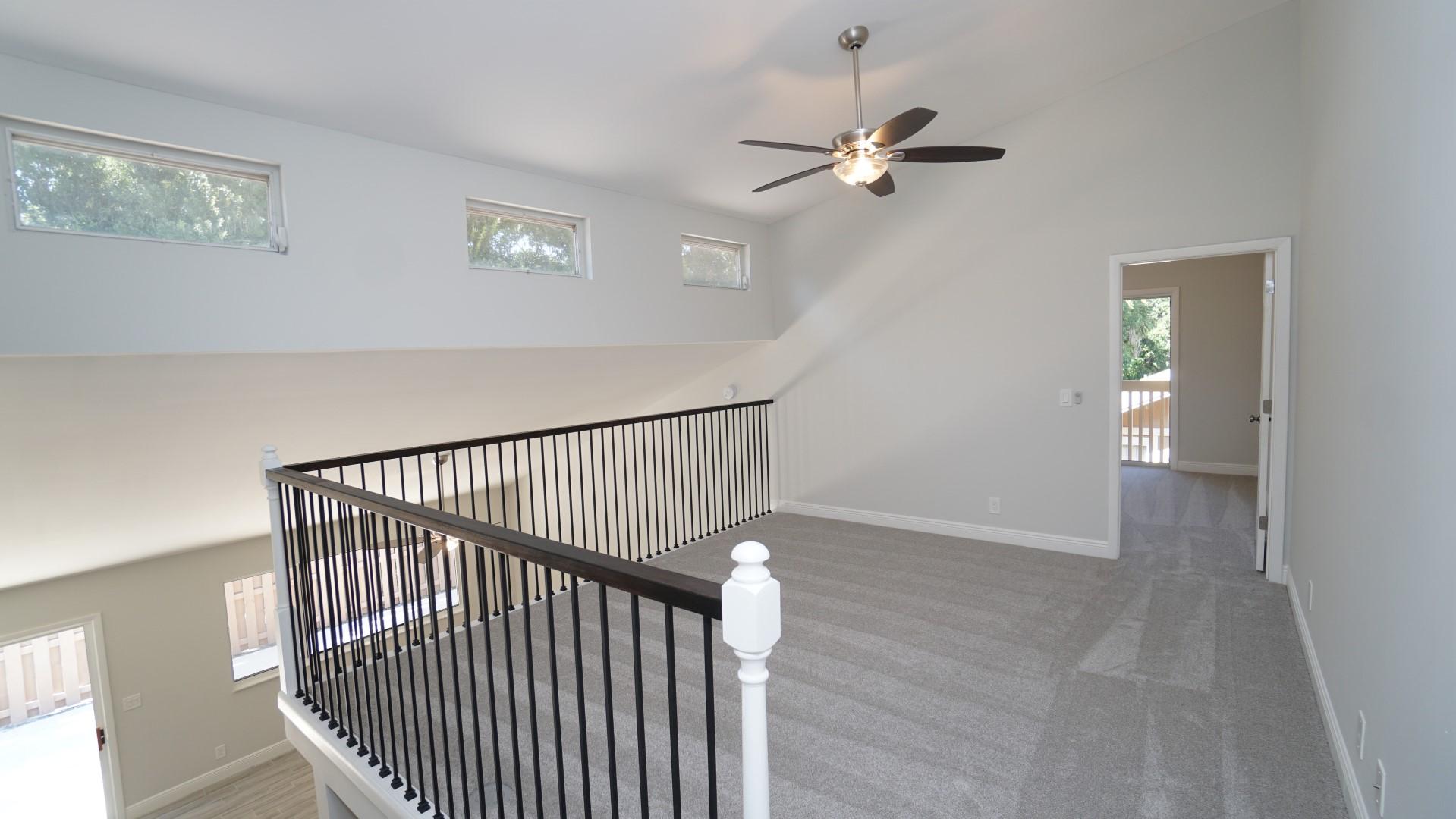 91 Maplecrest Circle Jupiter, FL 33458 - Photo 21 of 27 a view of a hallway with wooden floor and windows