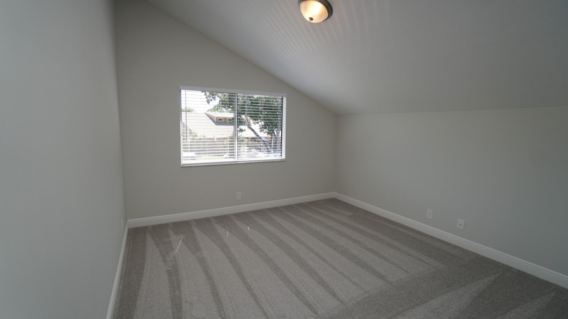 91 Maplecrest Circle Jupiter, FL 33458 - Photo 23 of 27 an empty room with wooden floor and windows