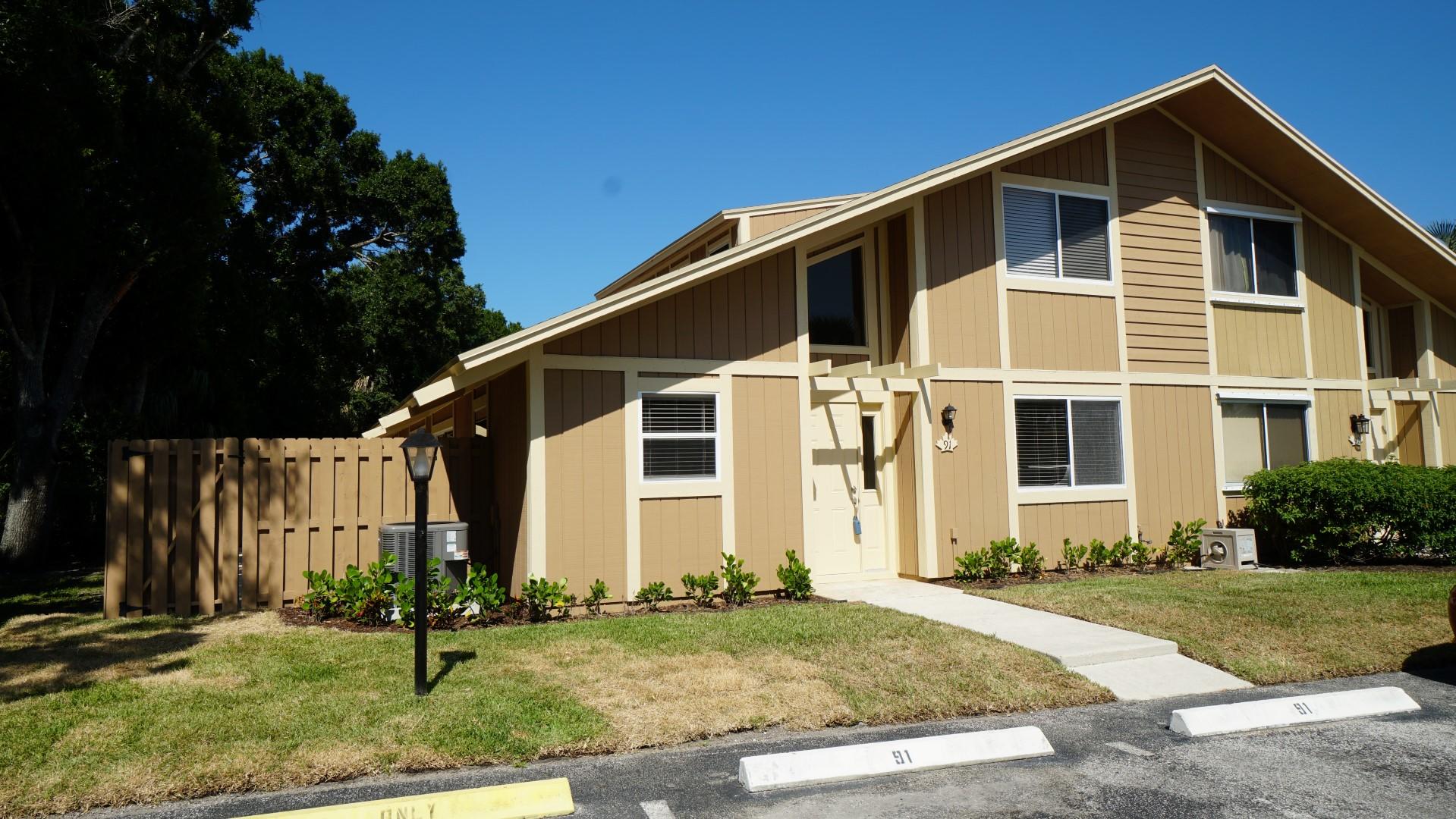 91 Maplecrest Circle Jupiter, FL 33458 - Photo 3 of 27 a front view of a house with a yard