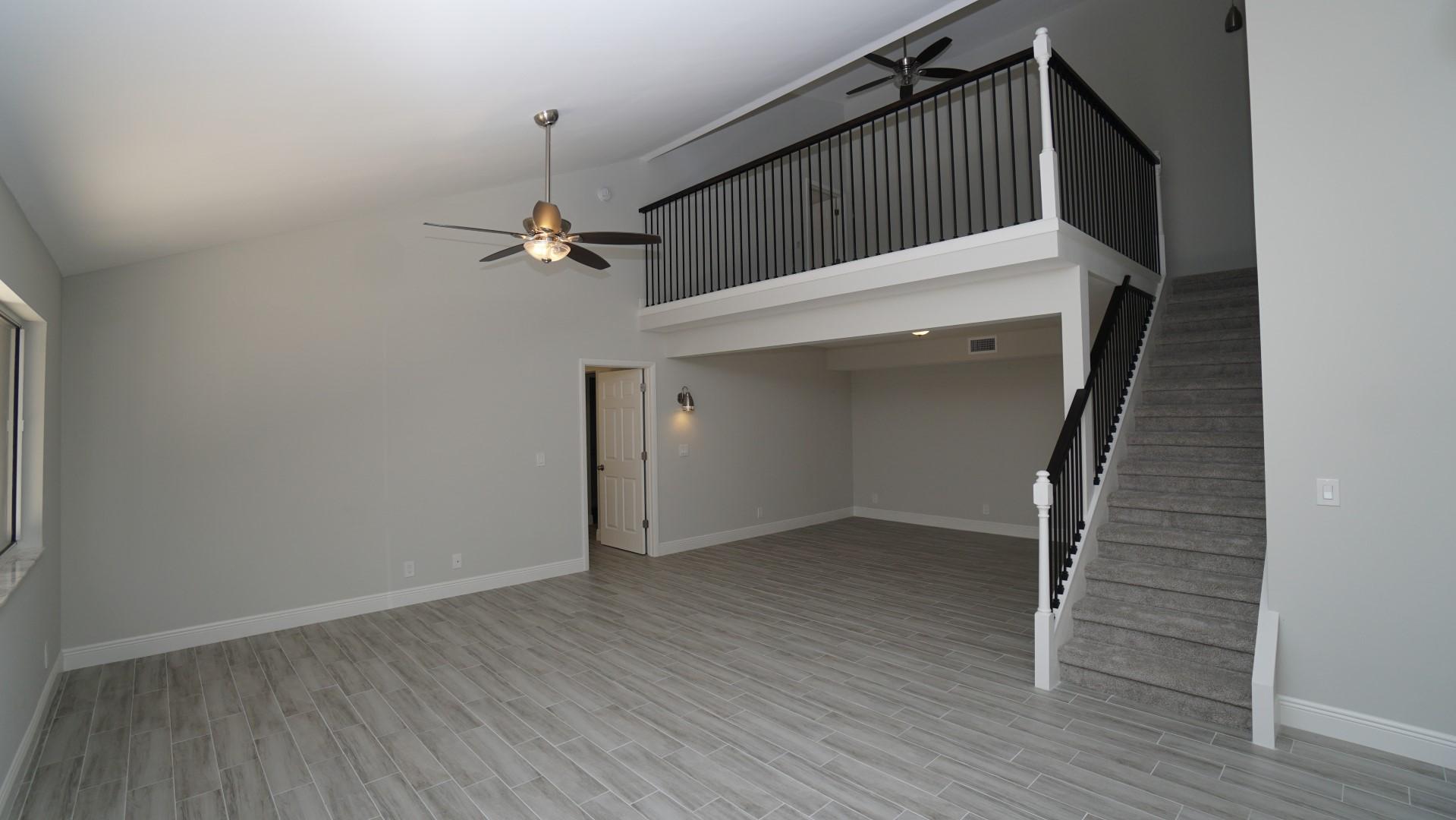 91 Maplecrest Circle Jupiter, FL 33458 - Photo 8 of 27 an empty room with wooden floor and windows