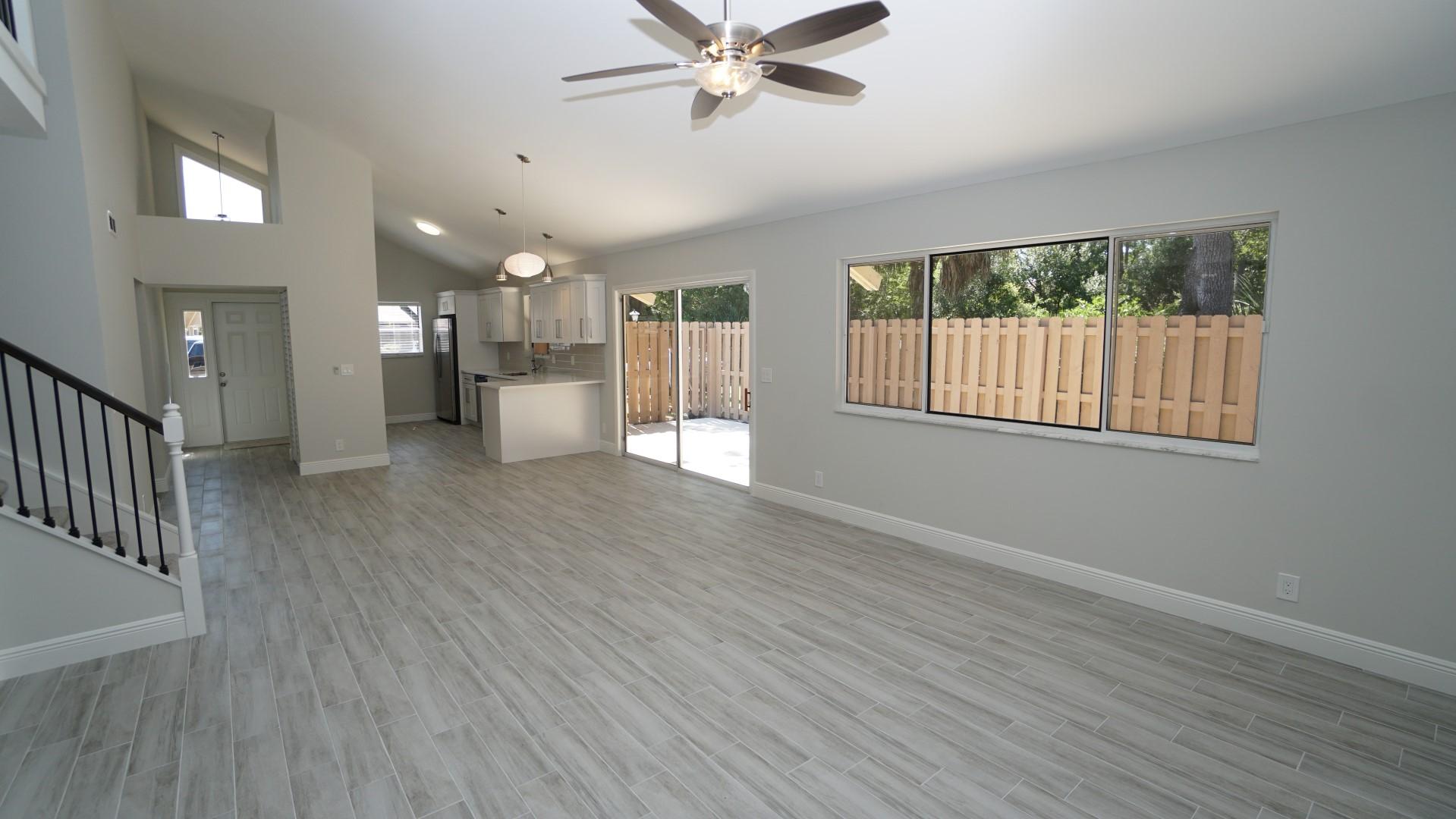 91 Maplecrest Circle Jupiter, FL 33458 - Photo 10 of 27 a view of an empty room with a window and wooden floor