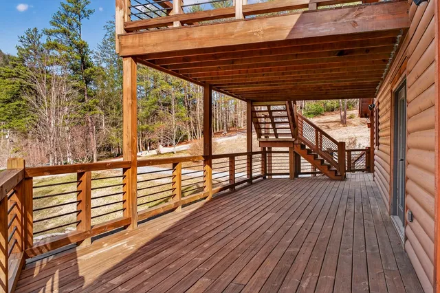 a view of a wooden deck with a yard