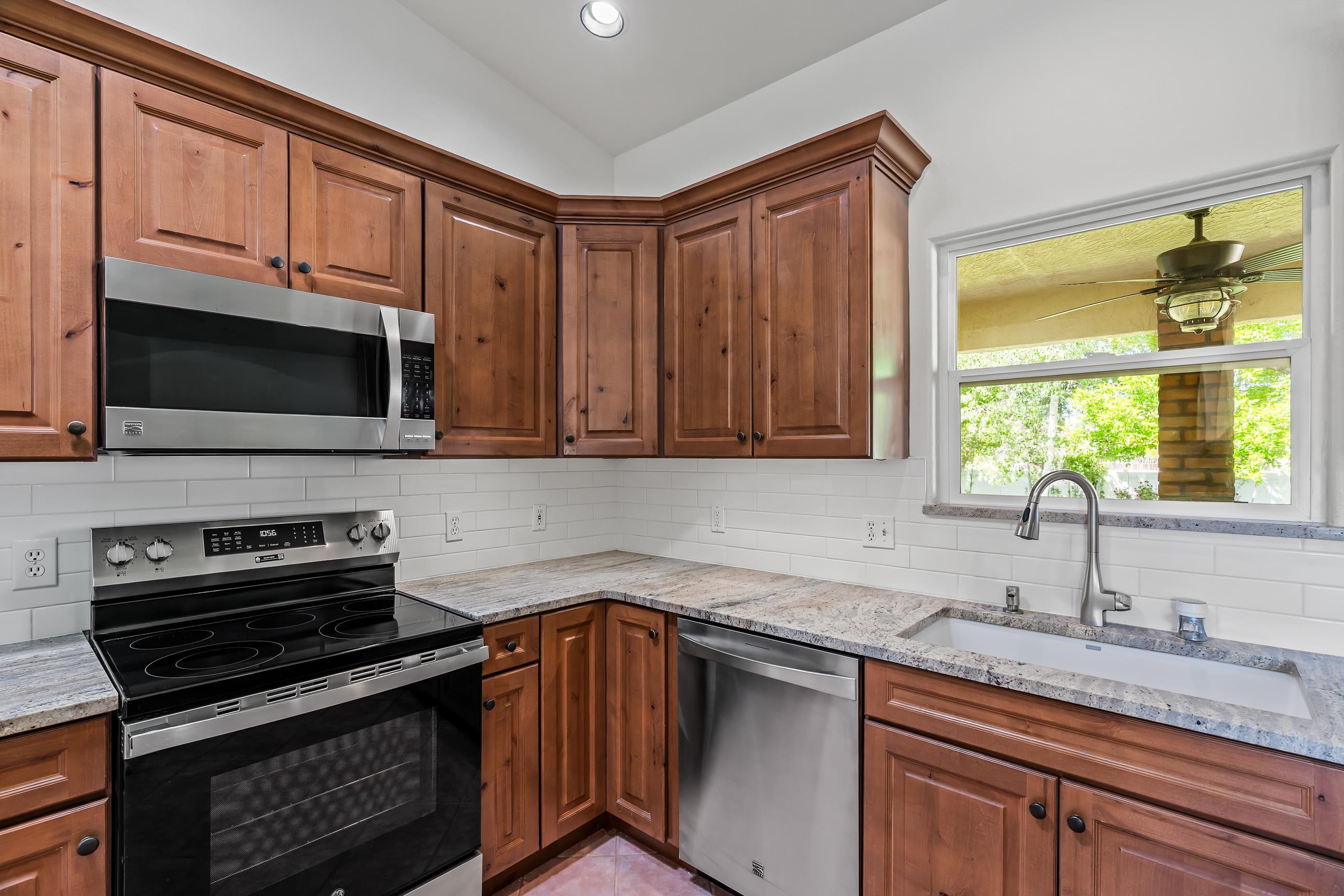705-24 24 3/4 Road Grand Junction, CO 81505 - Photo 7 of 27 a kitchen with stainless steel appliances a stove sink microwave and cabinets