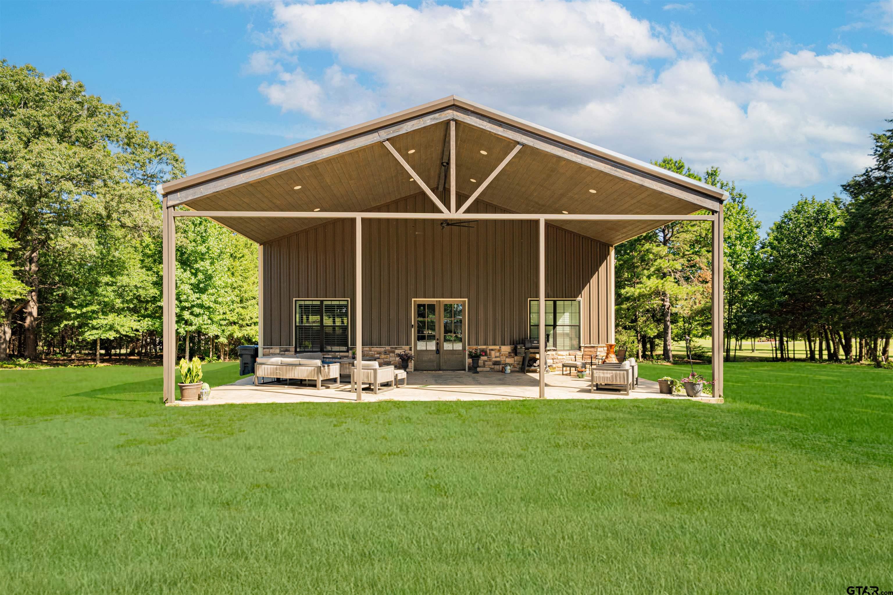 7635 Highway 271 Mount Pleasant, TX 75455 - Photo 1 of 46 a patio with a table and chairs and a big yard