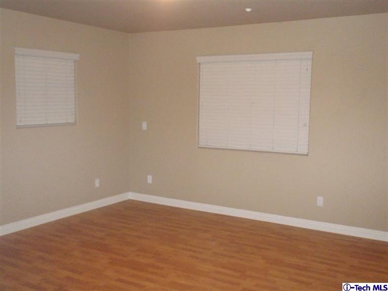 11533 Ranchito Street El Monte, CA 91732 - Photo 16 of 30 an empty room with wooden floor and windows
