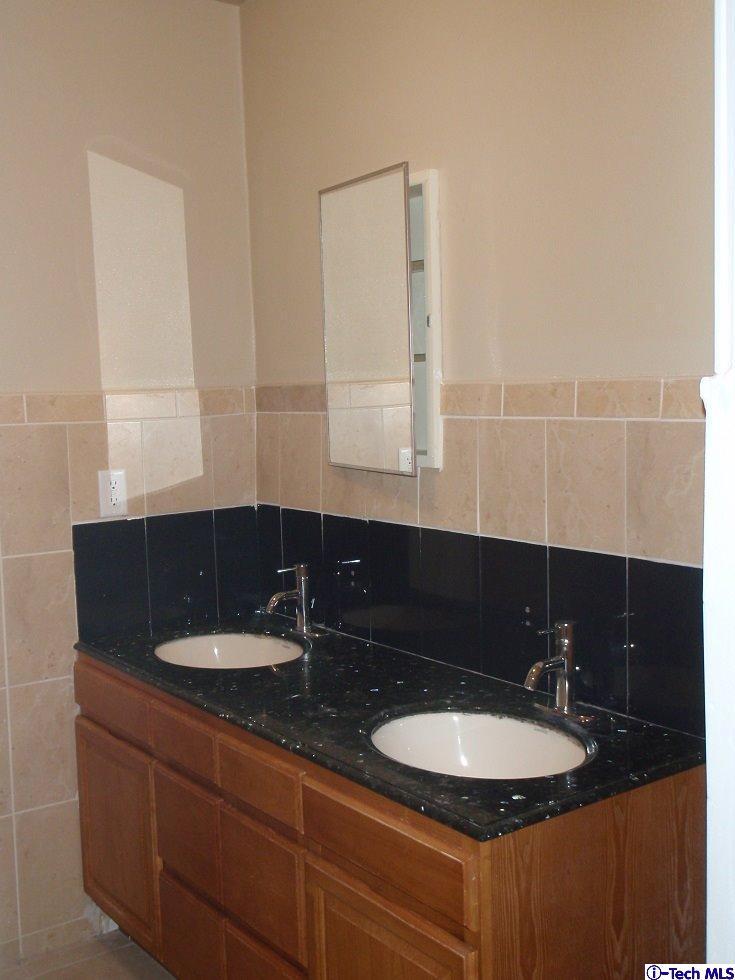 11533 Ranchito Street El Monte, CA 91732 - Photo 17 of 30 a bathroom with a sink and a mirror