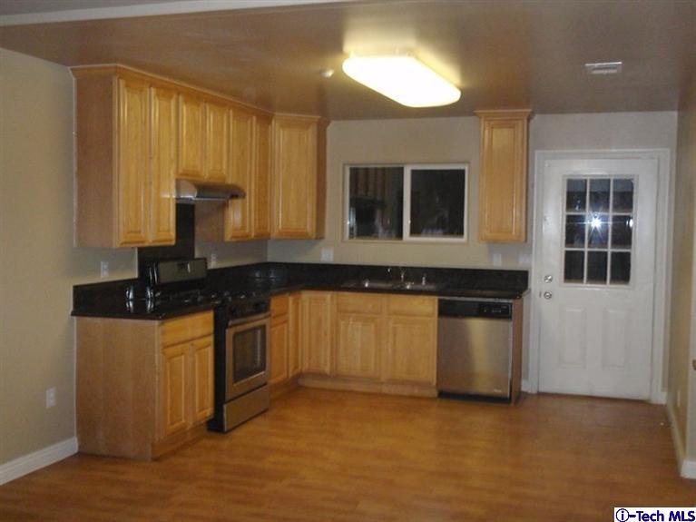 11533 Ranchito Street El Monte, CA 91732 - Photo 20 of 30 a kitchen with granite countertop a stove and a sink