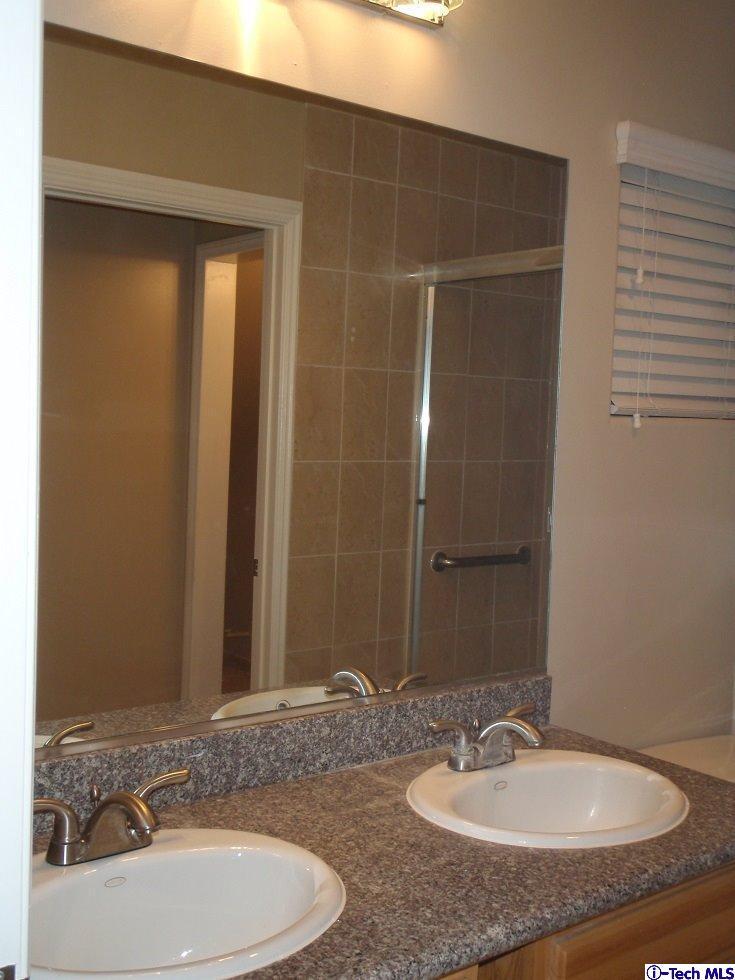 11533 Ranchito Street El Monte, CA 91732 - Photo 25 of 30 a bathroom with a sink and a mirror