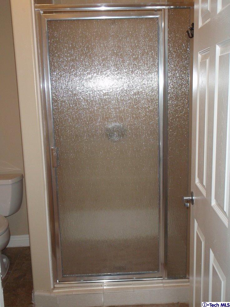 11533 Ranchito Street El Monte, CA 91732 - Photo 28 of 30 a bathroom with a glass shower door and a toilet