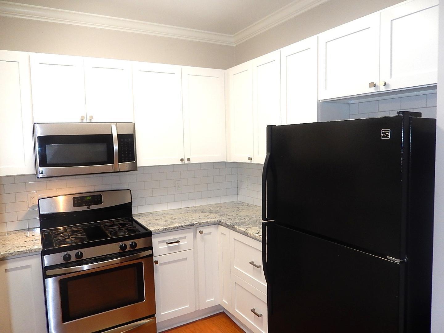211 Bridgepath Drive Cary, NC 27513 - Photo 9 of 26 a kitchen with a refrigerator stove and microwave