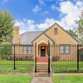 a view of a house with a big yard and large trees