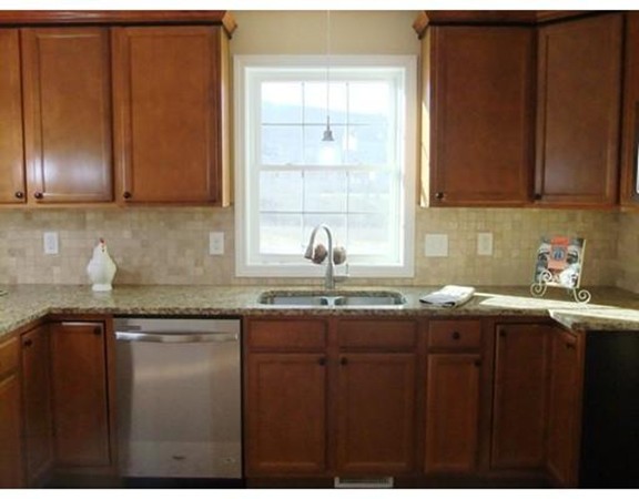 Lot 12 Bethany Road Monson, MA 01057 - Photo 13 of 25 a kitchen with granite countertop stainless steel appliances a sink and cabinets