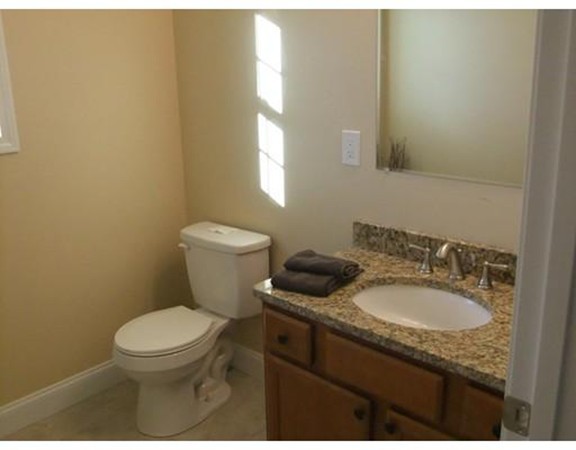 Lot 12 Bethany Road Monson, MA 01057 - Photo 16 of 25 a bathroom with a granite countertop toilet sink and mirror