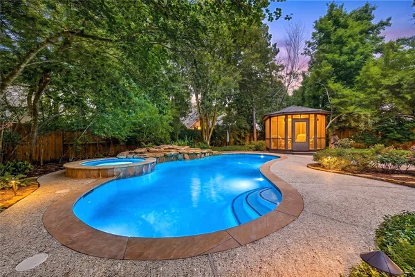 a view of a swimming pool with an outdoor seating and yard