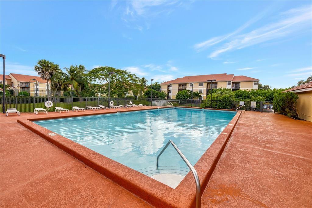 5781 Riverside Drive, Unit 201 Coral Springs, FL 33067 - Photo 18 of 23 a view of swimming pool with a yard and seating area