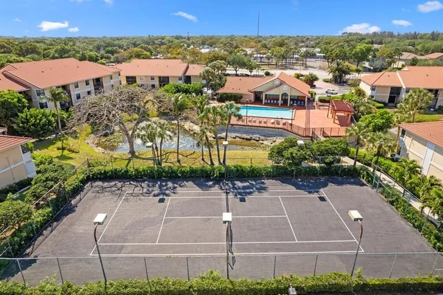 an aerial view of multiple houses with a yard