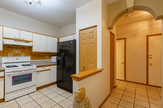 a kitchen with a refrigerator sink and stove