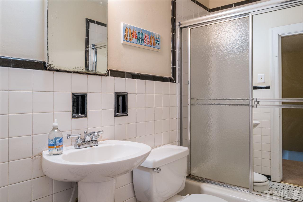 2254 The Circle Raleigh, NC 27608 - Photo 17 of 22 a bathroom with a sink toilet and shower