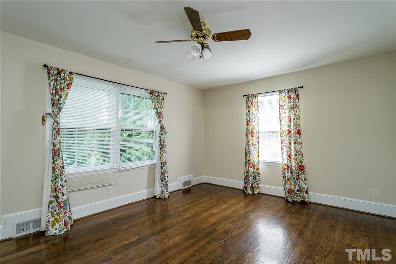 2254 The Circle Raleigh, NC 27608 - Photo 19 of 22 wooden floor in an empty room with a window