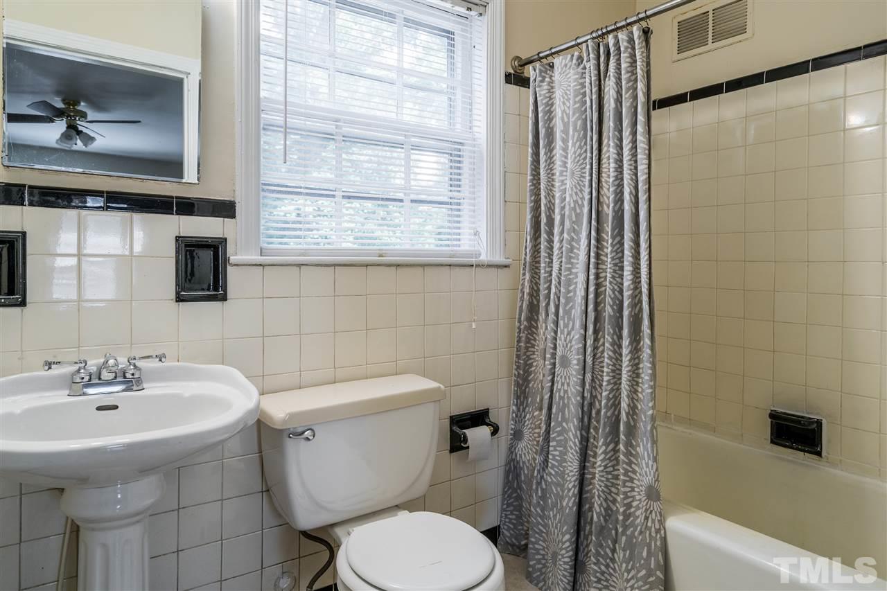 2254 The Circle Raleigh, NC 27608 - Photo 20 of 22 a bathroom with a sink toilet and shower