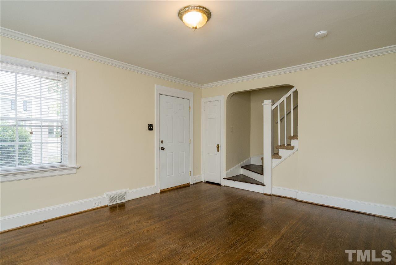 2254 The Circle Raleigh, NC 27608 - Photo 3 of 22 an empty room with wooden floor and windows