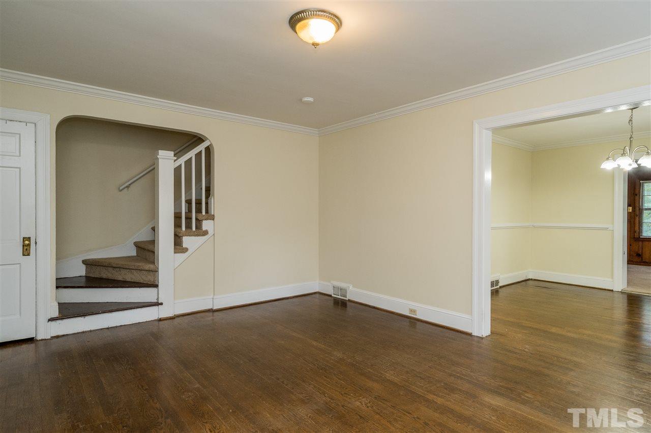 2254 The Circle Raleigh, NC 27608 - Photo 5 of 22 an empty room with wooden floor and mirror