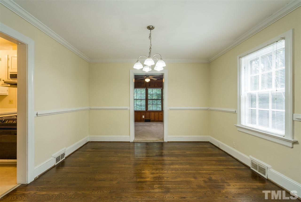 2254 The Circle Raleigh, NC 27608 - Photo 6 of 22 an empty room with wooden floor and windows