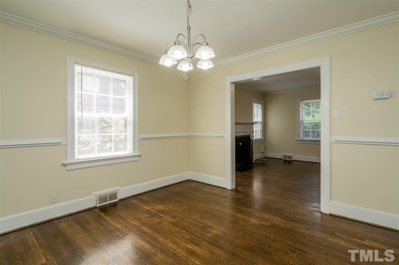2254 The Circle Raleigh, NC 27608 - Photo 7 of 22 wooden floor in an empty room with a window