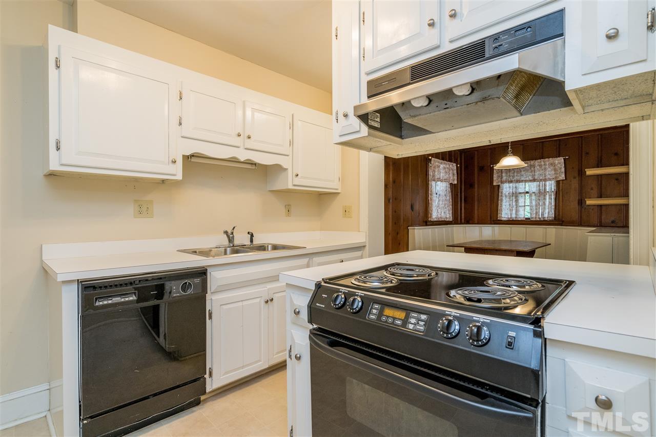 2254 The Circle Raleigh, NC 27608 - Photo 8 of 22 a kitchen with stainless steel appliances granite countertop a stove and a white cabinets