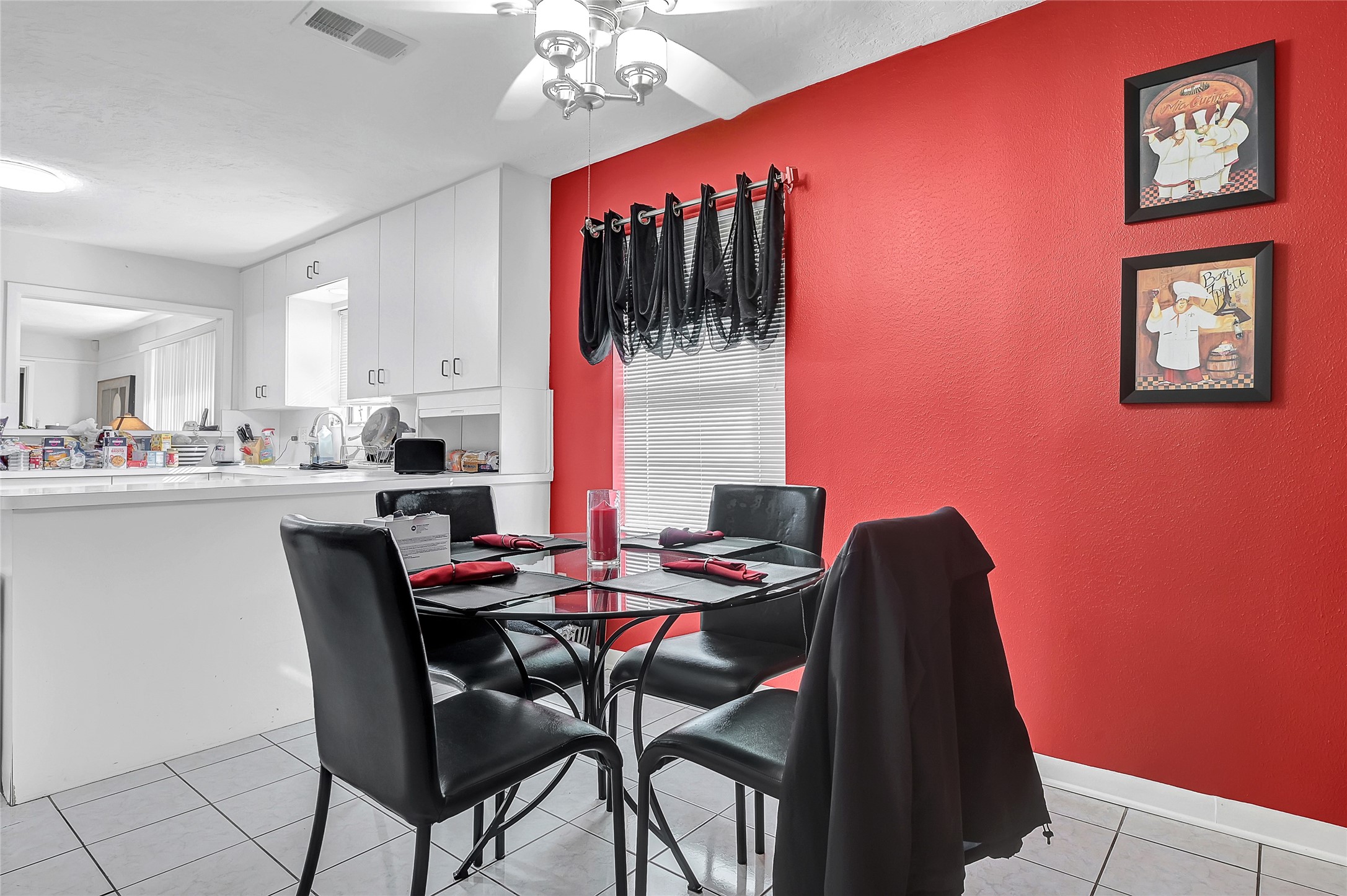 4831 Knickerbocker Street Houston, TX 77035 - Photo 29 of 50 Bold dining space with red wall accents, modern décor, and seating for gatherings.