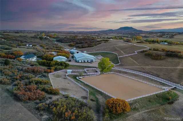 an aerial view of residential houses with outdoor space and street view