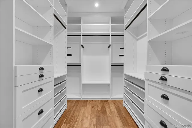a view of walk in closet with empty racks