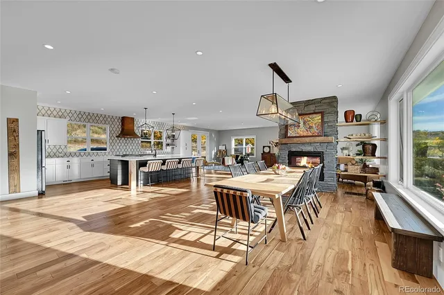 a living room with furniture a rug and kitchen view