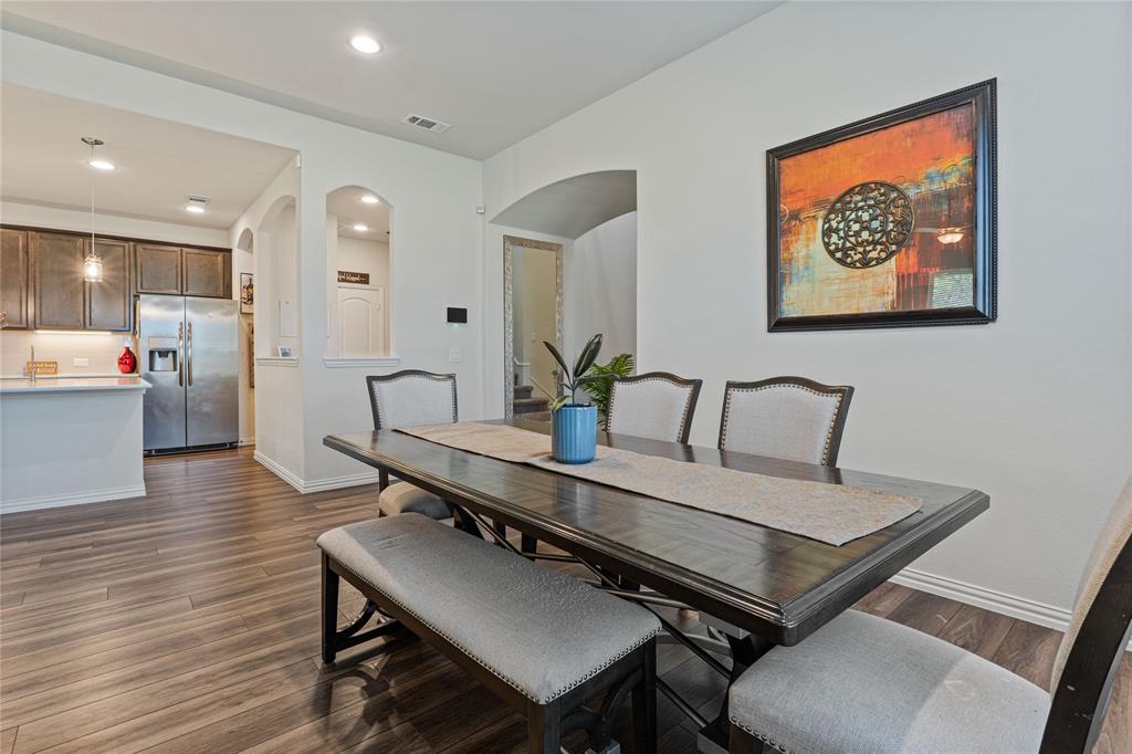 9517 Sunset Lane Oak Point, TX 75068 - Photo 10 of 40 9517 Sunset Lane, Oak Point, TX 75068 - dining area - Dining area with arched walkways, dark wood-type flooring, and recessed lighting