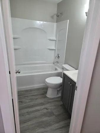 a bathroom with a toilet and a shower