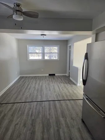 a kitchen with a sink and wooden floor