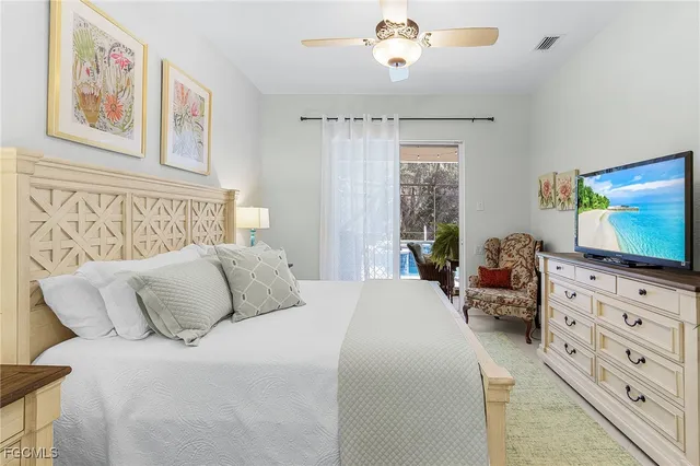 a bedroom with a bed and a lamp on dresser