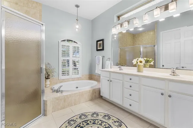 a bedroom with a bed a window and potted plant on a dresser